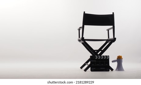 Back Of Black Director Chair And Black With Black Clapper Board And Megaphone On White Background