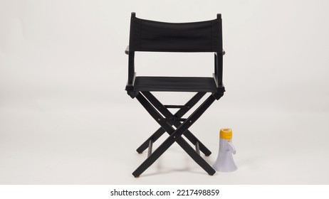 Back Of Black Director Chair And Megaphone On White Background.