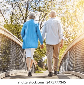 Back, bridge and senior couple holding hands, walking in park together for bonding or retirement. Garden, love or nature with elderly man and woman outdoor in summer for relationship or wellness - Powered by Shutterstock