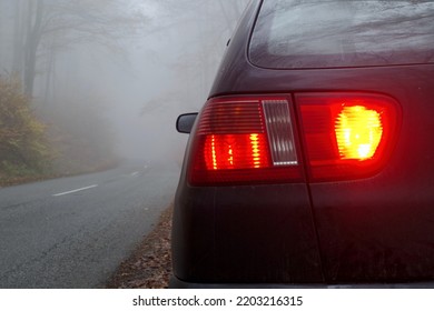 the back car light, rear fog and brake lights on the car on the early foggy. morning. bad conditions for driving - Shutterstock ID 2203216315