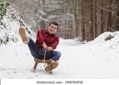 Back To Childhood - Happy Man Riding A Sledge, Having Fun And Laughing