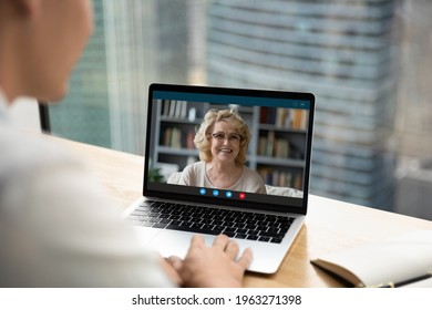 Back Close Up View Of Man Look At Laptop Screen Talk Speak On Video Call Online With Mature Mother. Male Have Webcam Digital Zoom Communication Or Conference On Computer. Virtual Event Concept.