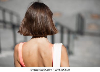 Back Close View Of Woman With Naked Shoulders And Backpack Short Bob Haircut Walk Down Stairs