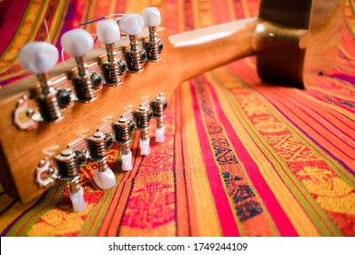 Back Of Colorful Charango Facing Up On Andean Blanket Seen From The Pegbox
