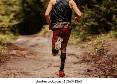 Back Dirty Man Runner In Compression Socks Running On Spring Trail