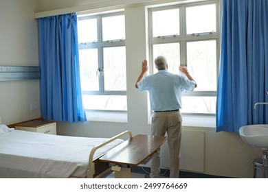 Back, elderly man and hospital in depression, stress or lonely by window with medical aid debt for senior care. Male person, mental health and anxiety in clinic for cancer treatment, illness or grief - Powered by Shutterstock