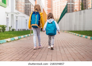 Back To Elementary,primary School.Little Girls,sisters With Big Backpack Go In Hurry,late To First Grade Alone In Autumn Morning.Education,future Of Children.Happy,unhappy Pupils Kids Walk Themselves.