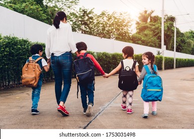 Back Family Parent Happy Children Kid Boy Son Kindergarten Holding Hand Carry School Backpack Walking Sidewalk To School. Young Mom Smile Have Funny, Back To School First Day Of Semester Concept