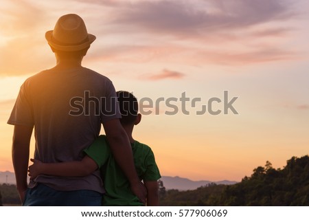 Back of father and son and sunset view.Dark tone