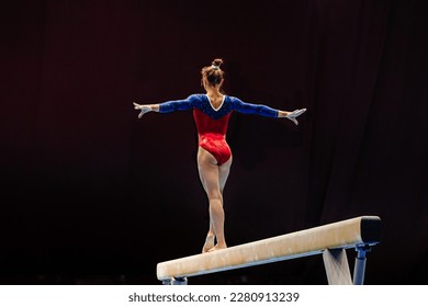 back female gymnast athlete balancing on balance beam gymnastics, sports summer games  - Powered by Shutterstock