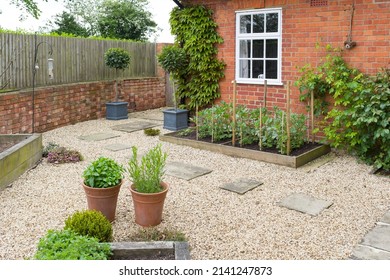 Back Garden UK. Landscaped Garden Design With Gravel, York Stone Stepping Stones And Oak Sleeper Raised Beds