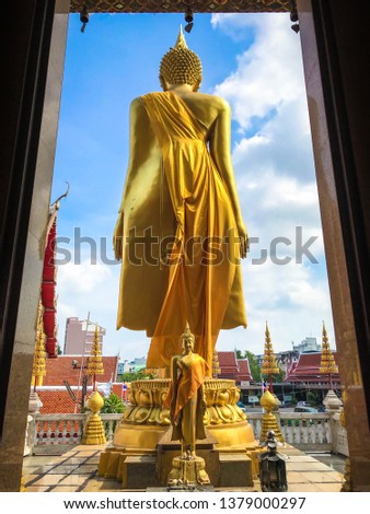 Back of golden standing Buddha statue. Stock fotó © 