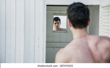 Back Of Handsome Shirtless Smiling Young Man Entering In Cabana Door, Male Surfer Standing In Doorway Of Rustic Beach Hut