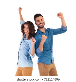 Back To Back Happy Couple Celebrating Victory With Hands In The Air On White Background