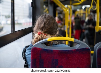 The back of the head of a girl with curly hair on a tram - Powered by Shutterstock