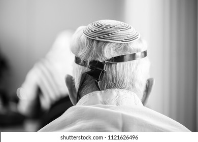 Back Of Head Of Older Jewish Man Donning Leather Straps Called 