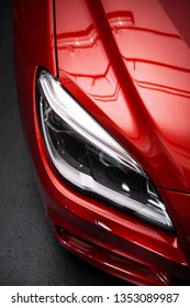 Back Headlight Of A Modern Luxury Red Car, Auto Detail, Car Care Concept In The Garage