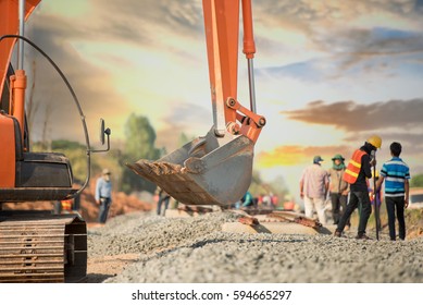 Back Hoe And Blurred Construction Worker In Safety Uniform In Railway Construction,construction Site Background 