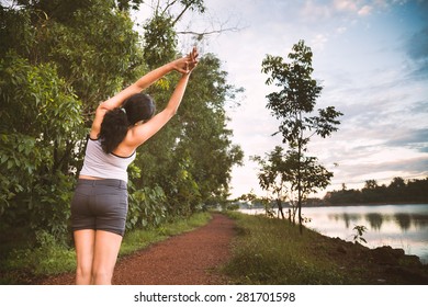 Back Of A Indian Girl Doing Morning Streching Exercise Very Near To Lake 