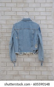 Back Jean Shirt ,jacket Hanging On White Brick Wall