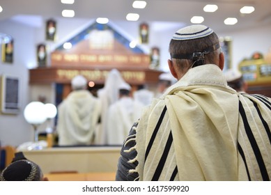 back of a jewish man on synagogue praying