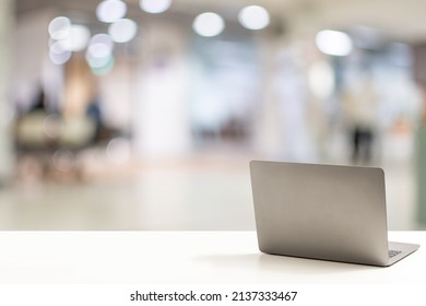 The Back Of The Laptop Is Blank, Placed On A White Desk In An Office, And Nobody. Technology Work Concept, Smartphone, Notebook, Internet, Left Side Copy Space, Close Up, Blurred Background.