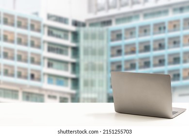 The Back Of The Laptop Is Blank, Placed On A White Desk, And Nobody, No People. Technology Work Concept, Smartphone, Notebook, Internet, Left Side Copy Space, Close Up, Blurred Background.