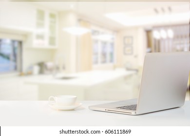 Back Laptop And Coffee On Wood Table In Modern Kitchen Room. 