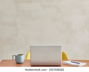 The Back Of Laptop In The Room, Wooden Table Yellow Chair Coffee Style.