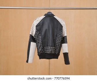 Back Of Leather Punk Rivets Jacket Hanging-wooden Background
