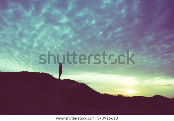 Back light\
silhouette of a man standing on a hill, overlooking, filtered\
vintage - future, power, achievement\
concept