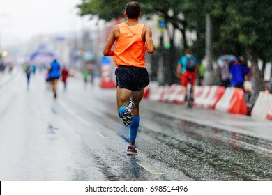 Back Man Athlete Runner Running City Marathon In Rain