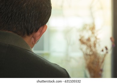 the back of the man is contemplating