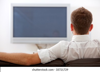 Back Of Man Watching Tv On A Sofa