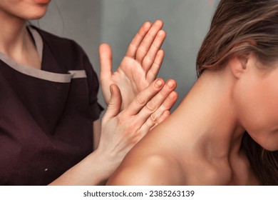 Back massaging procedure for adult woman in beauty SPA salon, medical therapy. Masseur female doing neck massage for lady patient. Healthy lifestyle, well-being concept. Copy ad text space - Powered by Shutterstock