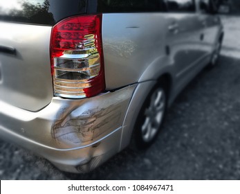 Back of mini van (MPV car) get damaged from accident on the road. Vehicle bumper dent and taillight broken by car crash. Road accidents and car insurance concept.