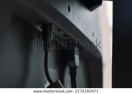 Back of monitor. Computer ports and blurry cables