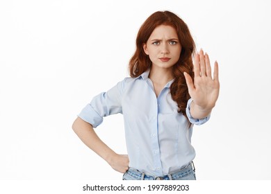 Back Off I Said No. Angry Redhead Woman Extend One Hand To Block, Say Stop, Prohibit Something With Displeased Frowning Face, Keep Social Distancing Dont Come Closer, White Background