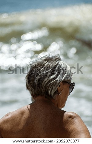 Back of an Old lady’s head at the beach