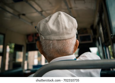 Back of old man white hair wearing white hat sit up  Bus ride in Thailand - Powered by Shutterstock