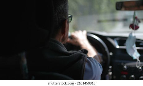 Back Of Older Man Driving On Road. Senior Driver On Trip