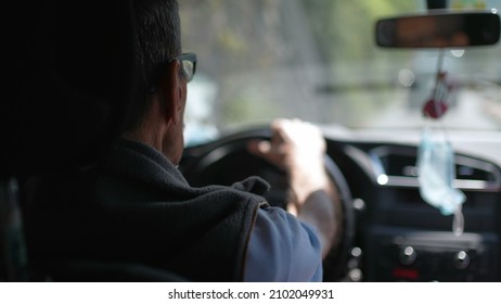 Back Of Older Man Driving On Road. Senior Driver On Trip