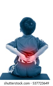 Back Pain. Athlete Asian Boy Sitting And Rubbing The Muscles Of His Lower Back, Isolated On White Background. Color Increase Blue Skin And Red Spot Indicating Location Of Pain. Studio Shot.