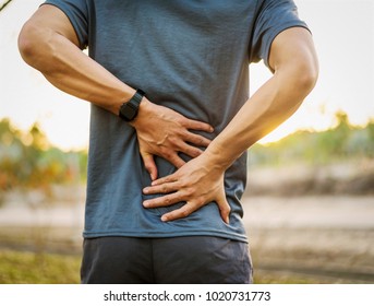 Back Pain, Close Up Young Man Has Injury During Outdoor Exercise