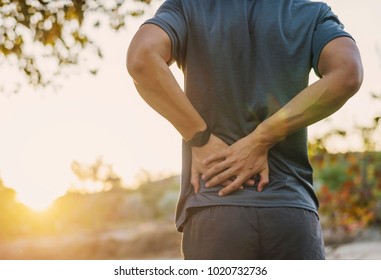 Back Pain, Close Up Young Man Has Muscle Injury During Outdoor Exercise