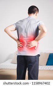 Back Pain, Kidney Inflammation, Man Suffering From Backache At Home, Painful Area Highlighted In Red