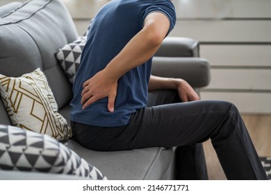 Back pain, kidney inflammation, man suffering from backache at home, health problems concept - Shutterstock ID 2146771771