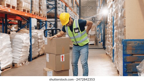 Back pain, man and boxes in warehouse for injury, overworked and strain with inventory. Logistics, male worker and backache in factory for export, commerce and packaging for trade or shipping - Powered by Shutterstock