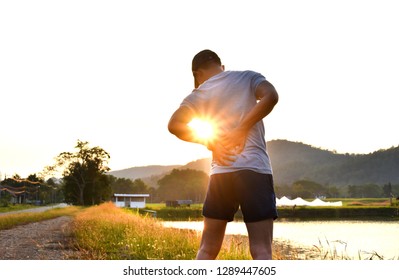 Back Pain, Young Sports Man Has A Pain At The Lower Back During Outdoor Exercise, Exercise Relief Pain Concept