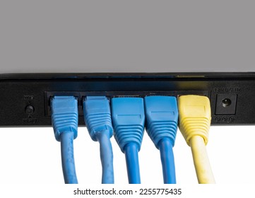 The back panel of a small router and switch with interface cables connected. tcp ip network business concept. High-performance gigabit switch. The back panel of the home network switch. - Shutterstock ID 2255775435